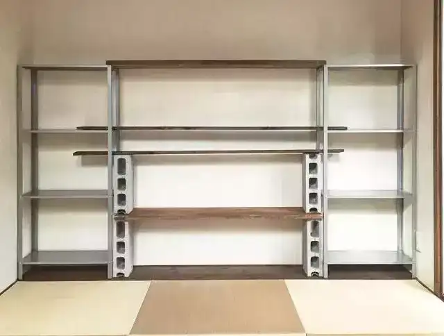 A living room storage shelf made of metal aluminum frames and wooden partitions