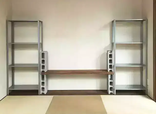 A living room storage shelf made of metal aluminum frames and wooden partitions