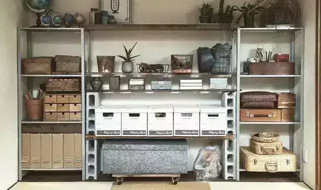 A living room storage shelf made of metal aluminum frames and wooden partitions